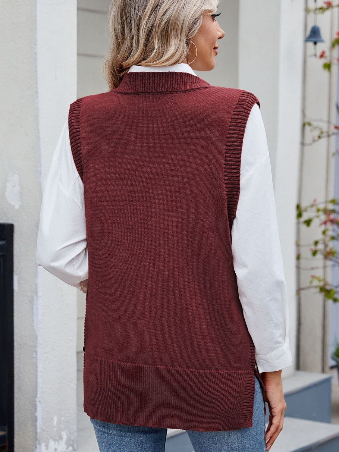Burgundy ribbed knit vest with side buttons, collared neckline, and a relaxed fit.
