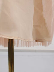 Embroidered tulle midi dress with pleated hem detail in a soft peach hue.