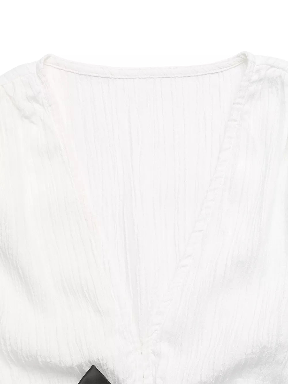 White crinkle fabric maternity blouse with V-neck and cap sleeves, featuring a bow detail.