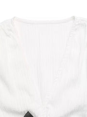 White crinkle fabric maternity blouse with V-neck and cap sleeves, featuring a bow detail.