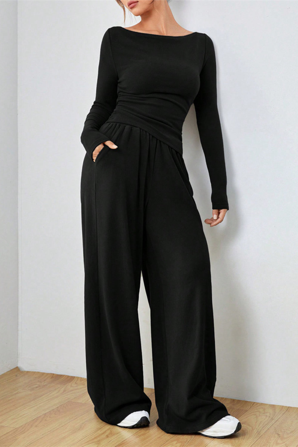 Black boat neck loungewear set with long sleeves and wide-leg pants with pockets.