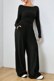 Black boat neck loungewear set with long sleeves and wide-leg pants with pockets.
