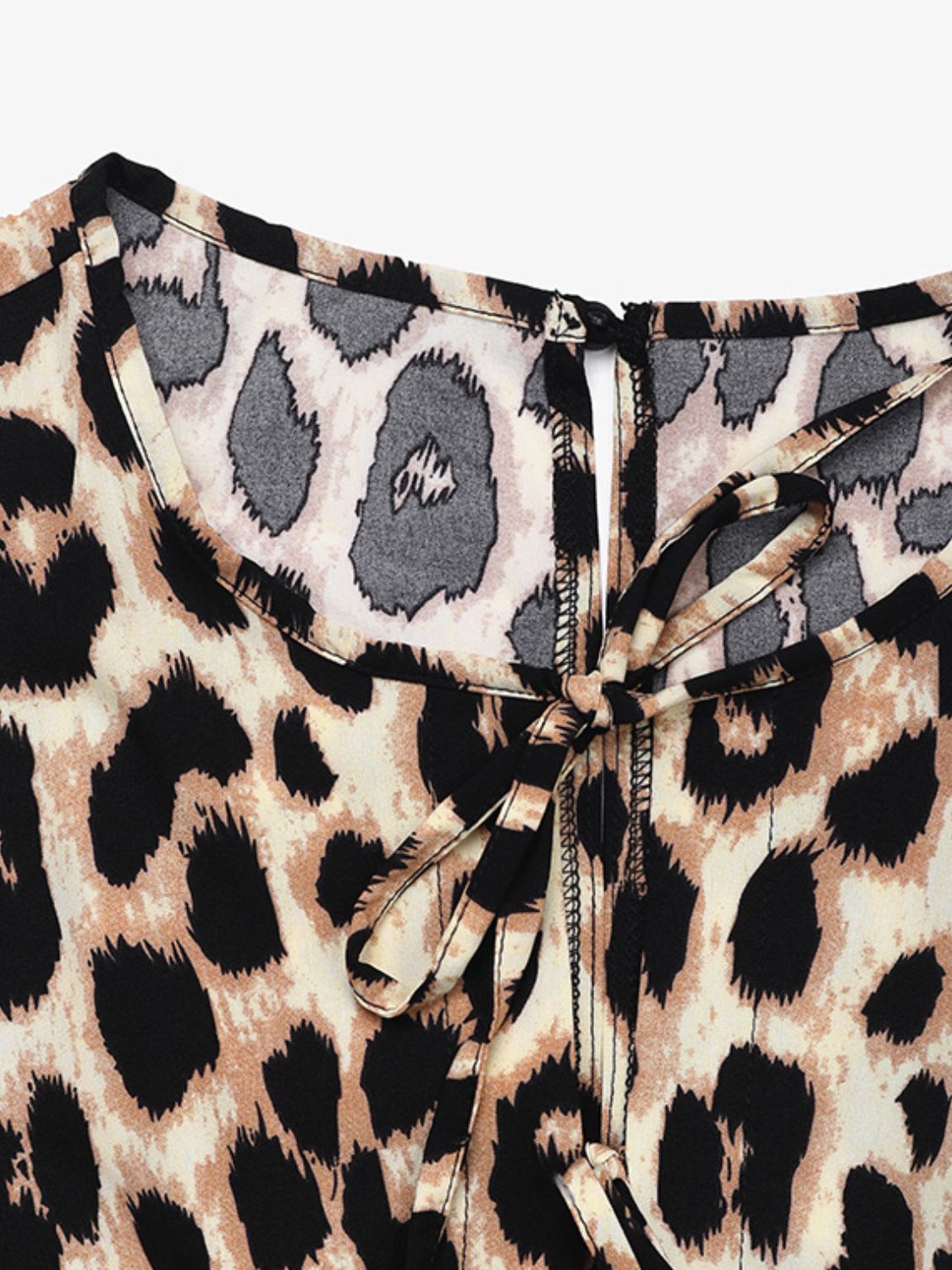 Leopard print jumpsuit with tie-neck detail and puff sleeves