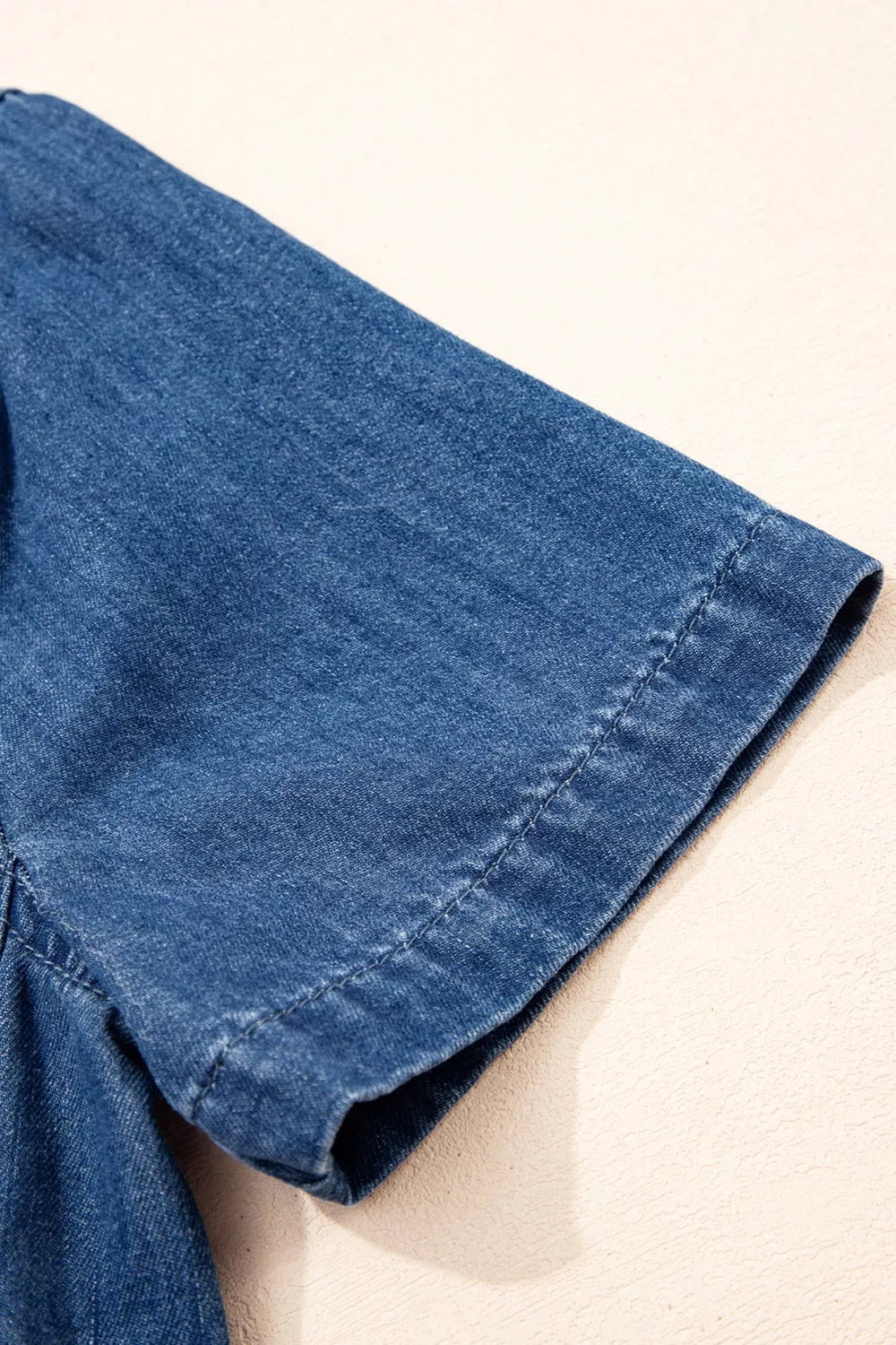 Blue denim collared mini shift dress with short sleeves and visible stitching detail.