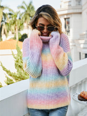 Chunky knit turtleneck sweater with rainbow gradient stripes and a cozy acrylic blend.
