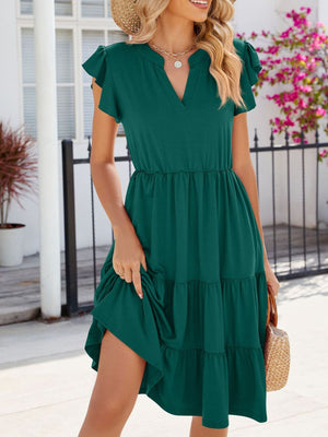 Dark green ruffled midi dress with notched V-neck and tiered skirt.