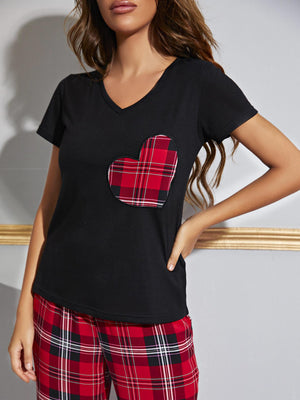 Black v-neck tee with red plaid heart pocket and matching plaid lounge pants.