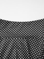 Black polka dot two-piece set with ruffled crop top and flared skirt detail.