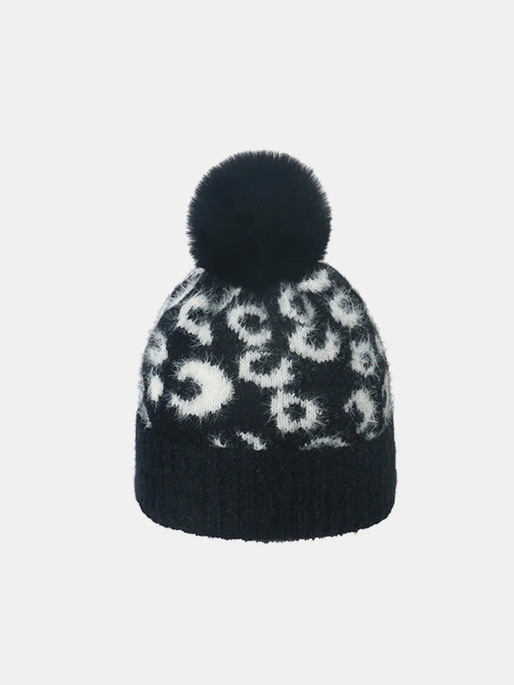 Black and white leopard print knit beanie with a black pom pom.