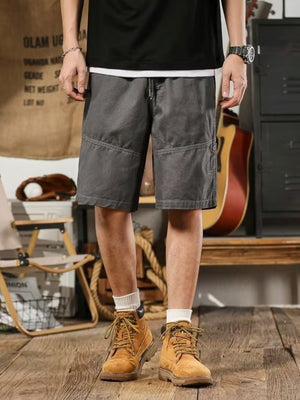 Men's gray drawstring shorts relaxed fit with cargo pockets and contrast stitching.