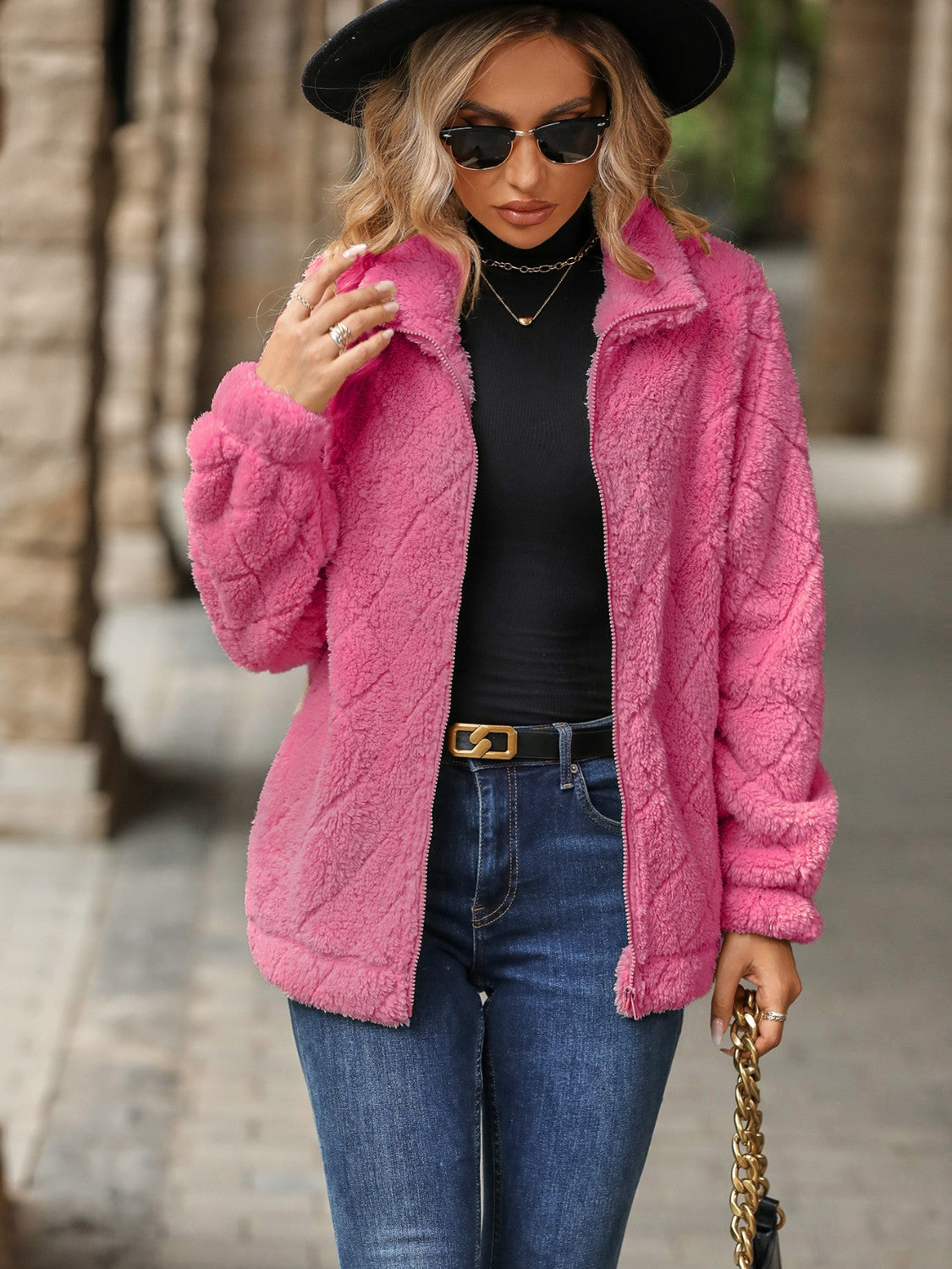 Pink textured teddy zip-up jacket with a diamond pattern, collared neckline, and long sleeves.