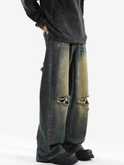 Men's vintage distressed wide-leg jeans in blue denim with ripped knees.