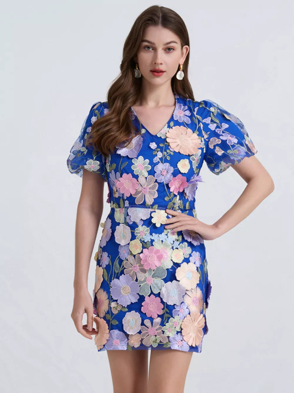 Royal blue mini dress with colorful floral embroidery and puff sleeves.
