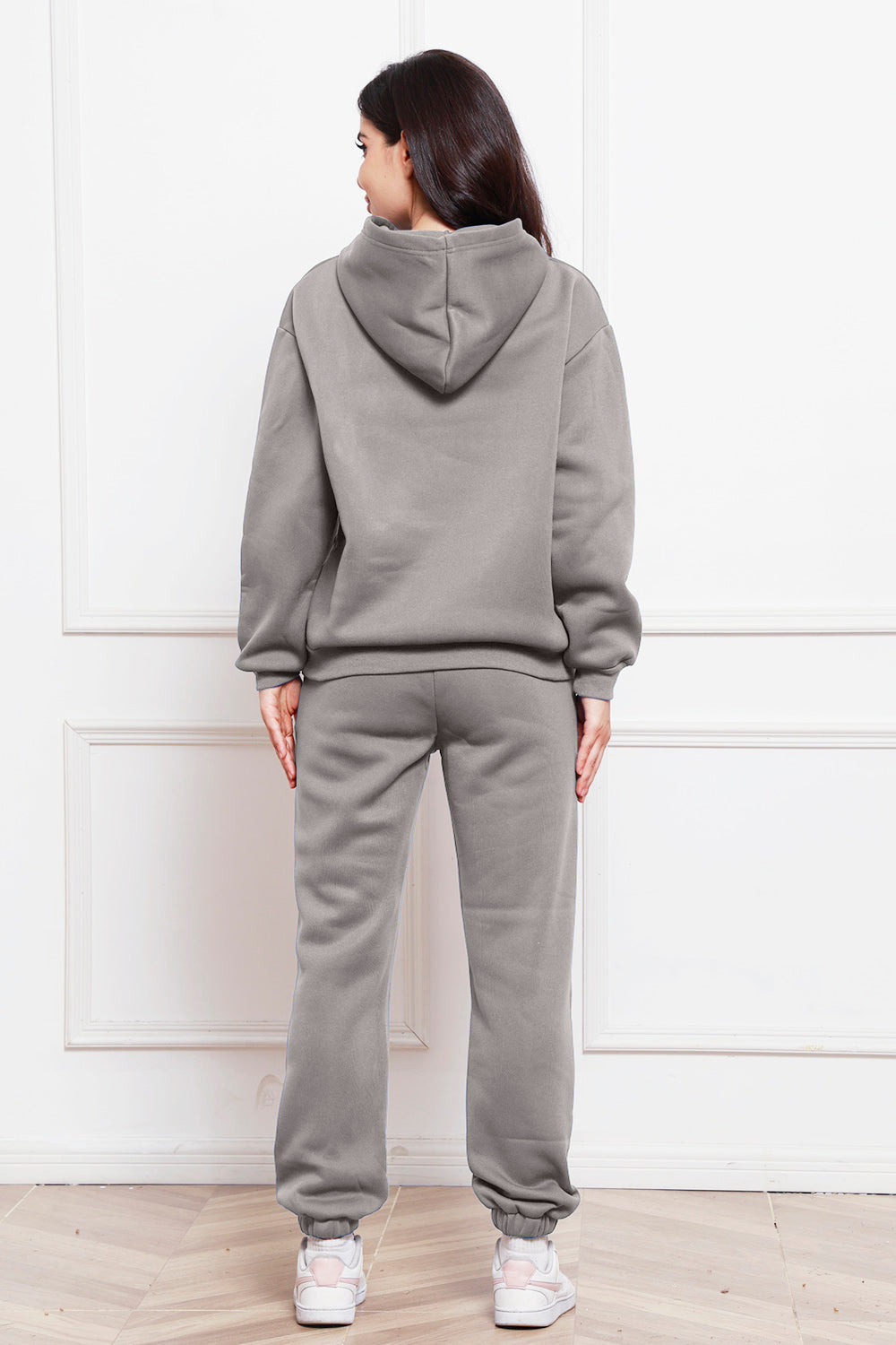 Gray relaxed fit hoodie and joggers set with cuffed ankles.