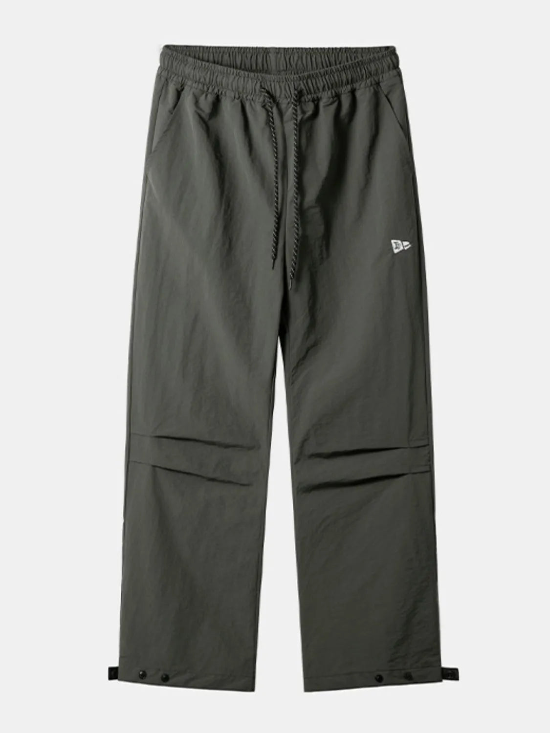 Dark gray utility joggers with drawstring waist, cargo pockets, and snap button ankles.