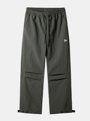 Dark gray utility joggers with drawstring waist, cargo pockets, and snap button ankles.