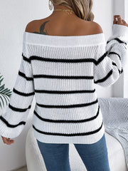 Off-the-shoulder white knit pullover with black stripes and long sleeves.