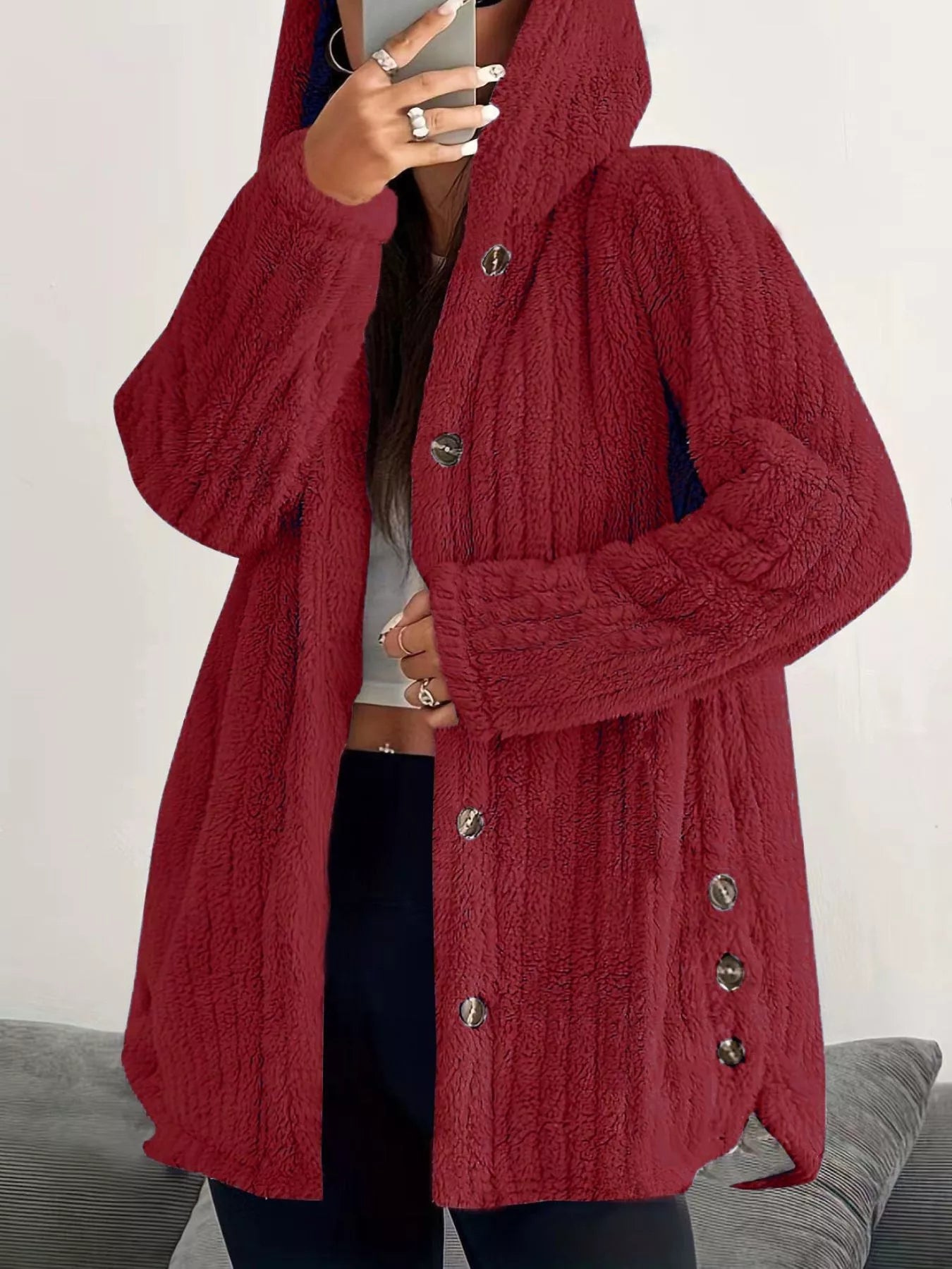 Red button-up fleece jacket with a hood and textured fabric.