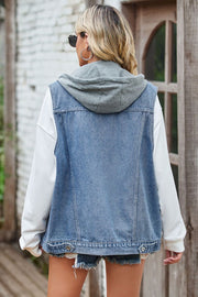 Denim hybrid vest with grey detachable hood, buttoned front, and distressed hem.