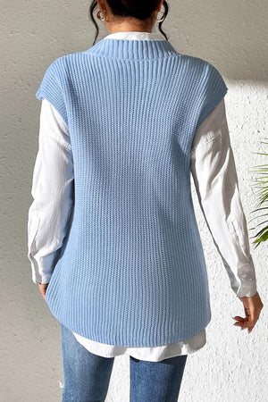 Light blue textured knit V-neck sleeveless top over a white button-down shirt.