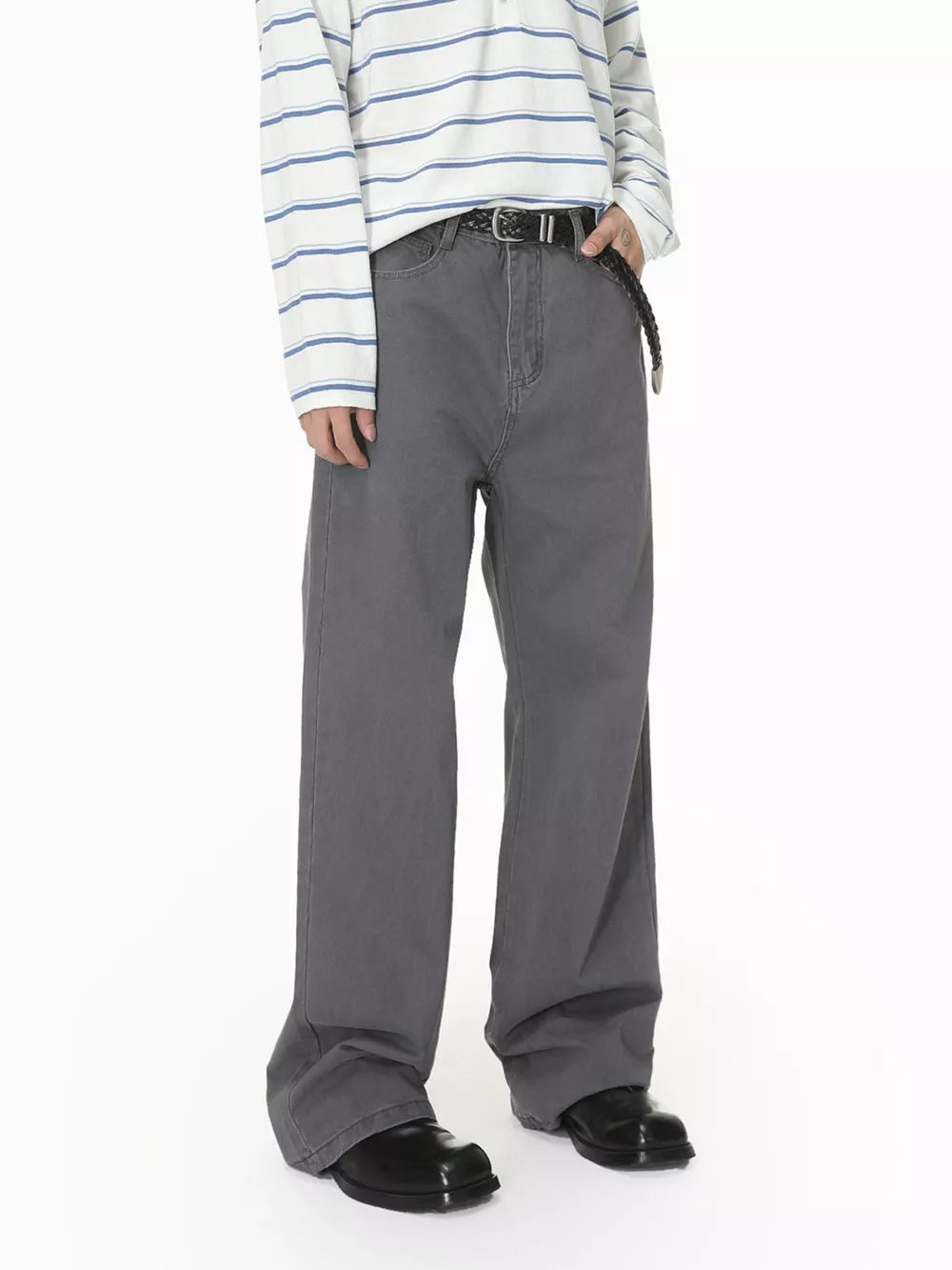 Men's grey cotton relaxed fit jeans with button closure and braided belt.