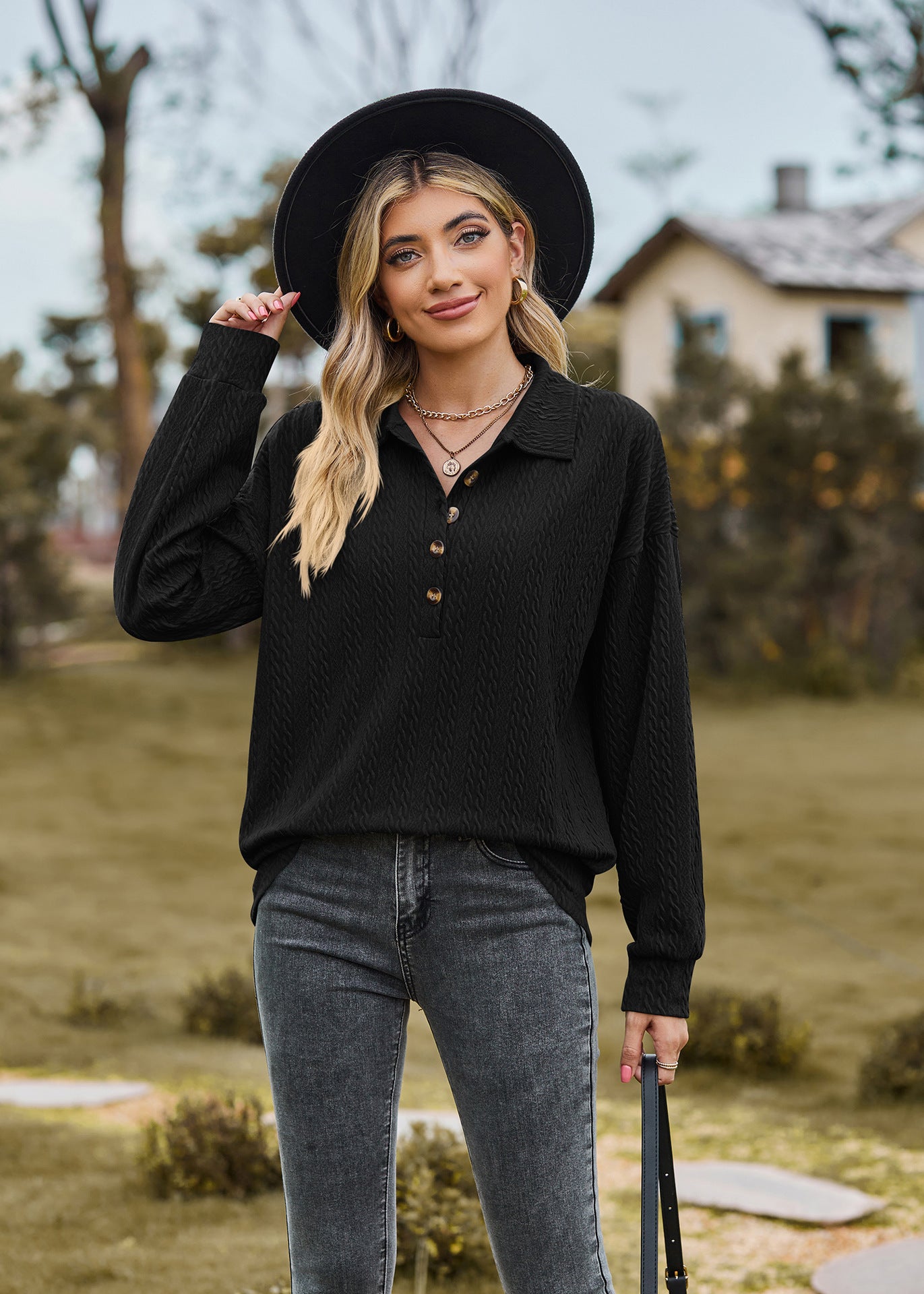 Black textured polo-neck sweater with button detail and long sleeves