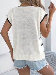 White cable knit sleeveless top with black trim and diamond pattern detail