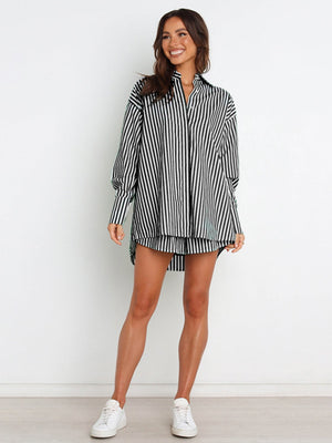 Oversized black and white stripe shirting set with a button-up top and matching shorts.