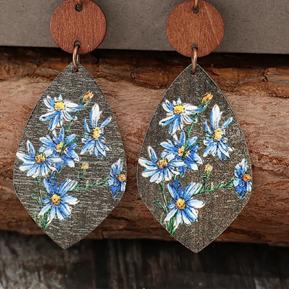 Botanical wood teardrop earrings with blue floral print and wooden top detail.