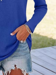 Blue ribbed knit half-zip sweater with long sleeves and a relaxed fit.