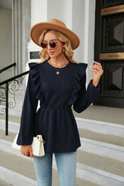 Navy textured ruffle peplum blouse with long sleeves and cinched waist.