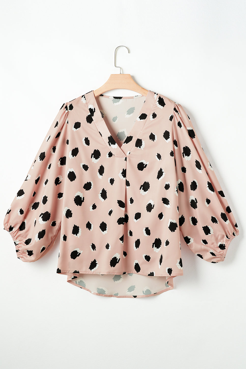 Pink silk blouse with blouson sleeves and a spot print.