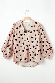 Pink silk blouse with blouson sleeves and a spot print.