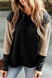 Black hoodie with textured tan sleeves and V-neck detail