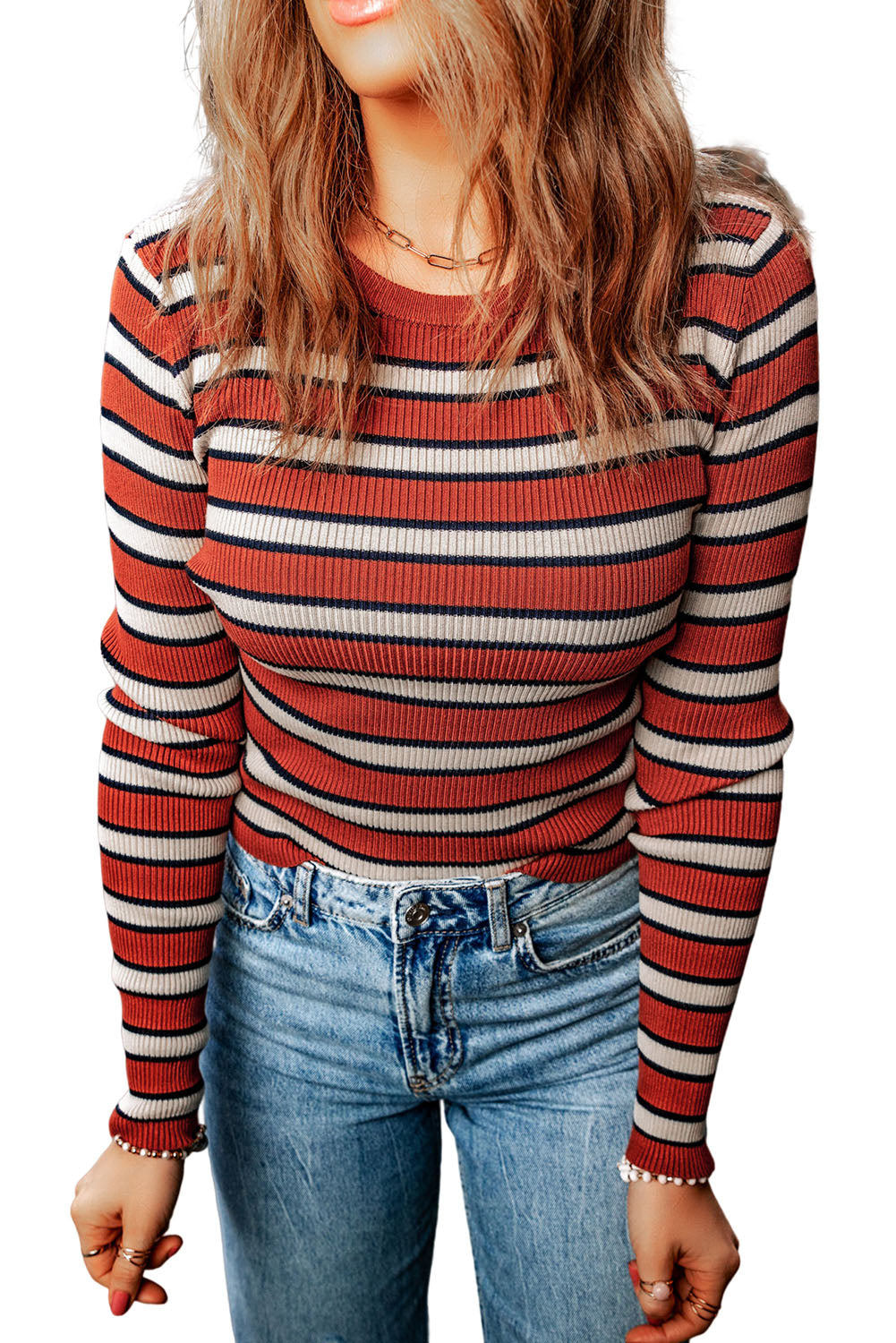 Ribbed knit crewneck sweater with horizontal stripes in rust, cream, and navy.