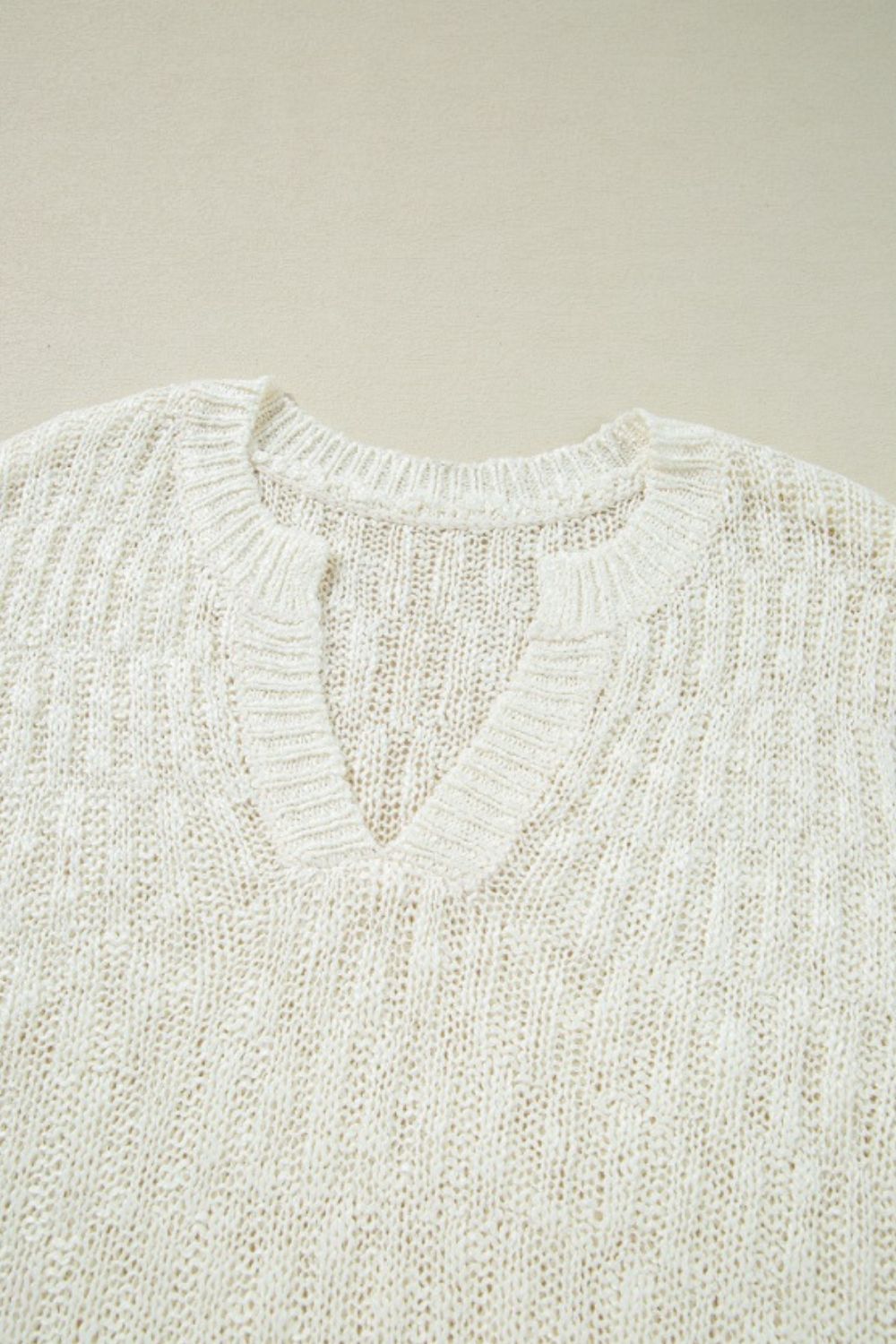 Beige textured knit V-neck shell top with ribbed neckline and cuffs