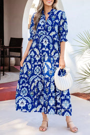 Vibrant floral maxi dress with frilled collar, buttoned front, and ruffled sleeves.