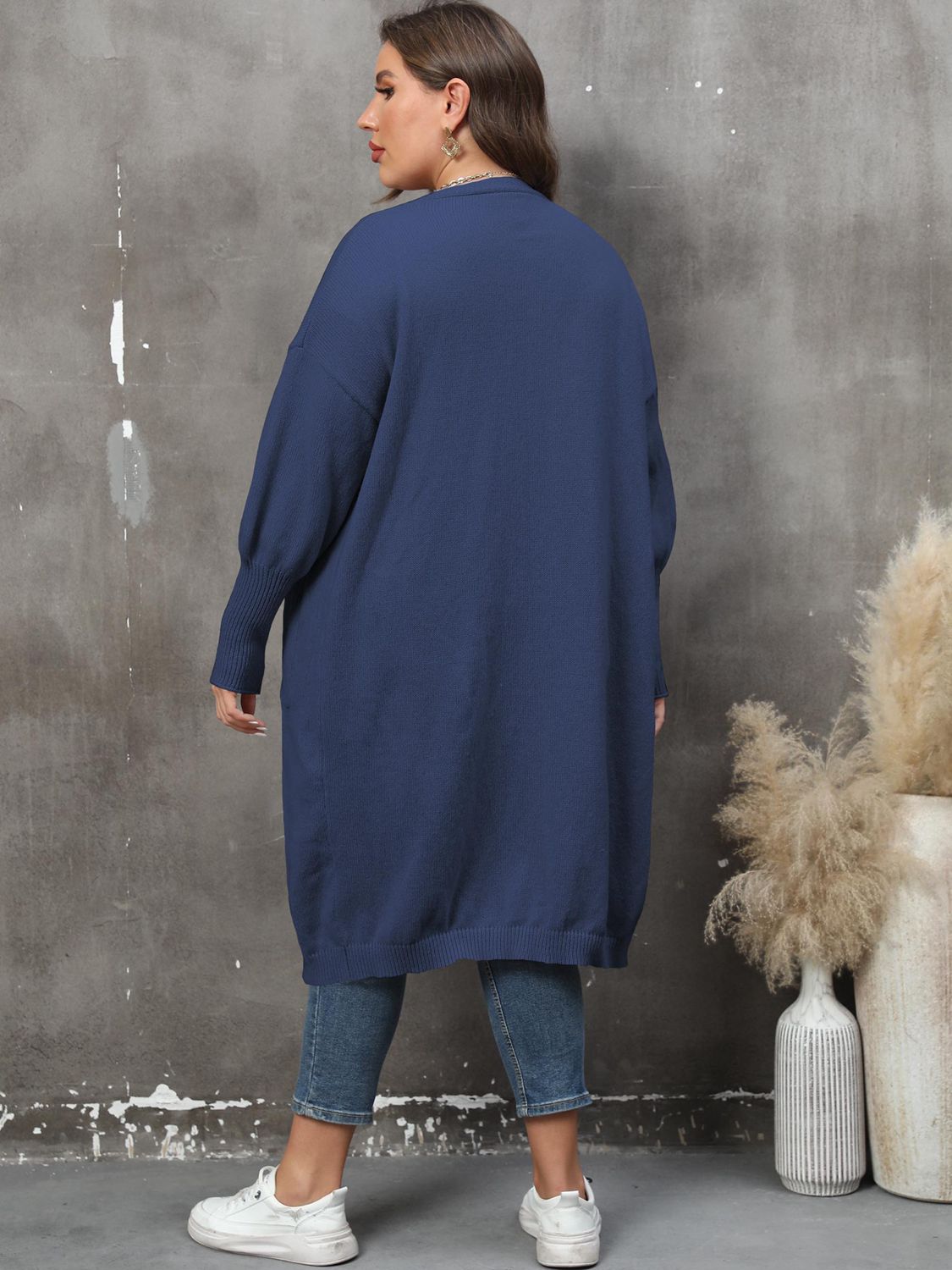Oversized dark blue knit duster cardigan with long sleeves and ribbed cuffs.
