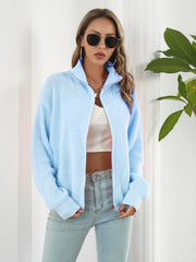 Pastel blue ribbed knit zip-up sweater with a mock neck and long sleeves.