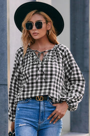 Black and white gingham blouse with gathered neckline and tie detail, balloon sleeves.