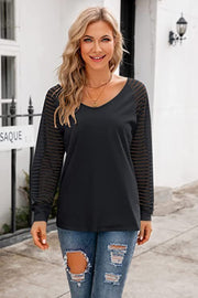 Black v-neck top with sheer striped raglan sleeves