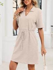 Textured polo dress in apricot with short sleeves and adjustable drawstring waist.