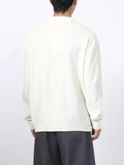 Textured knit polo shirt in white with a classic collar and long sleeves.