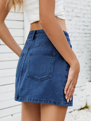 Classic denim mini skirt in medium blue with back pockets.