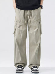 Loose fit khaki cargo pants with drawstring waist and multiple pockets.