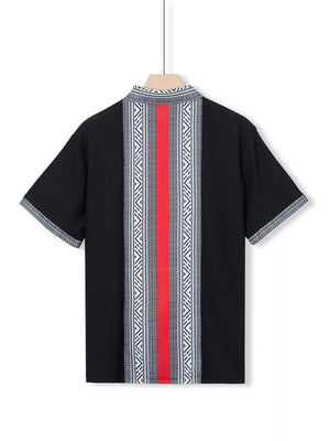 Black short sleeve men's shirt with bold geometric print and red stripe detail.