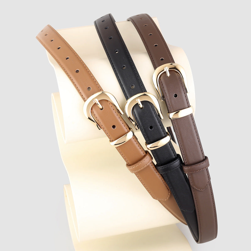 Leather belts in black, brown, and coffee brown with polished gold buckles.