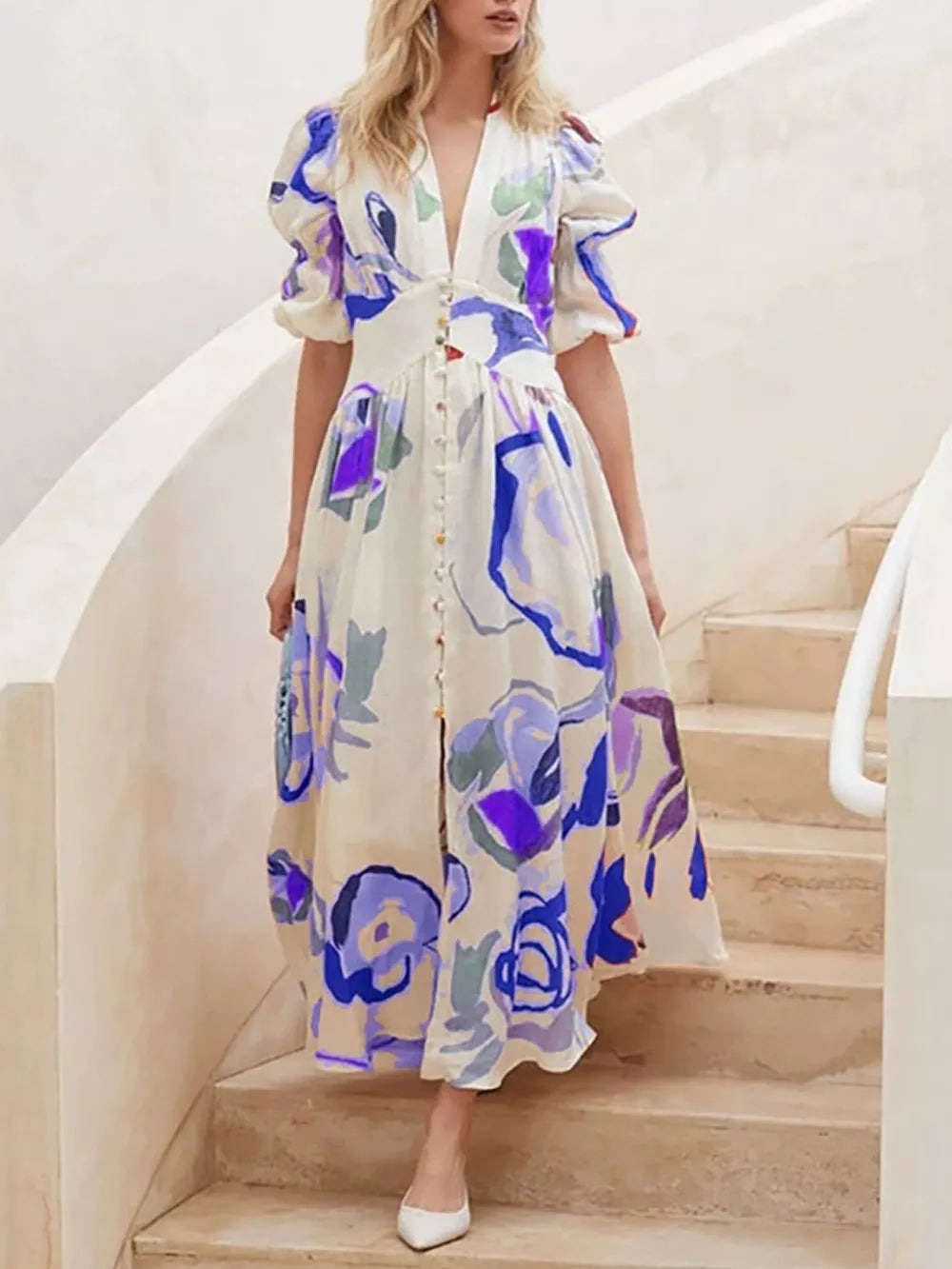 Midi dress with abstract print, puff sleeves, button front, and V-neck.