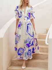 Midi dress with abstract print, puff sleeves, button front, and V-neck.