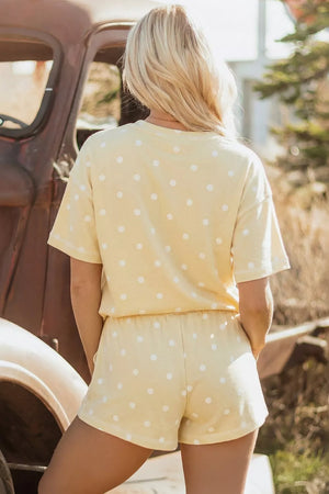 Yellow polka dot polyester shorts with drawstring waist.